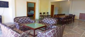 a room with chairs and a table and a dining room at Basera Lodges in Nathia Gali
