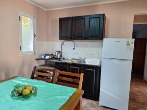 a kitchen with a table and a white refrigerator at DaLi in Montecarlo +3 photos