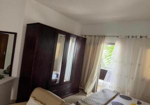 a living room with a cabinet and a window at Résidence Douce in Dakar