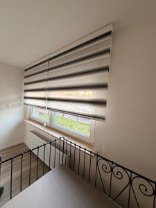 a window with a large blind in a room at WorkHome A2 zu 3 in Lünen