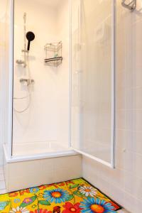 a bathroom with a shower and a colorful tile floor at Frankenblick in Frankenau +28 photos