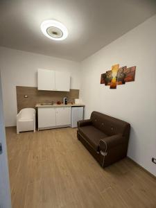 a living room with a couch and a kitchen at La Loggia sui Giardini in Mola di Bari