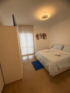a bedroom with a bed and a window at La Loggia sui Giardini in Mola di Bari +7 photos
