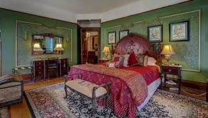 a bedroom with a large bed and green walls at Schuster Mansion Bed & Breakfast in Milwaukee