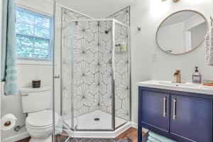 a bathroom with a shower with a toilet and a sink at The Moon Loft in Atlanta