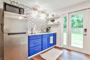 a kitchen with blue cabinets and a stainless steel refrigerator at The Moon Loft in Atlanta