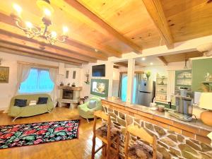 a kitchen and living room with a stone counter top at Clematis House in Voronet +47 photos