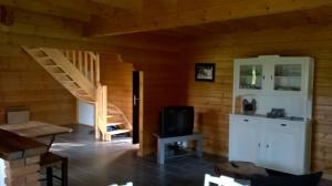 a room with a staircase in a wooden cabin at Le Chalet de Seb in Ingouville