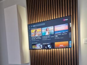 a television screen with a bunch of ads on it at APARTAMENT 2+2 in Konin
