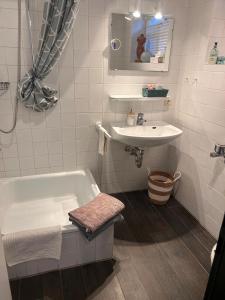 a bathroom with a bath tub and a sink at Gemütlichkeit im Grünen in Warendorf +45 photos