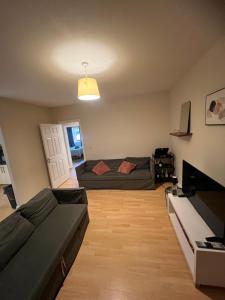 a living room with a couch and a bed at Kildare cozy home in Kildare
