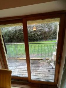 a sliding glass door with a view of a deck at Kildare cozy home in Kildare
