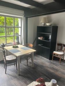 a dining room with a table and two chairs at Gemütlichkeit im Grünen in Warendorf