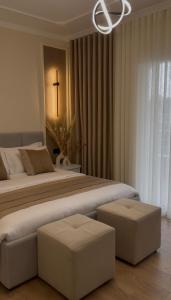 a bedroom with a large bed with a cross on the wall at Modern Luxury Apartment-City Center-Walk Anywhere in Durrës