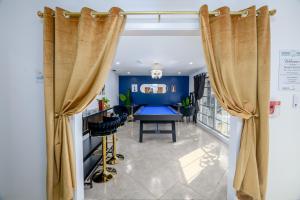 a dining room with a blue table and curtains at Sleeps36 2Homes 12BR Heated Pool Spa Pickleball 14 Parking in Clearwater