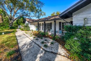 a house with a pathway leading to the front yard at Sleeps36 2Homes 12BR Heated Pool Spa Pickleball 14 Parking in Clearwater