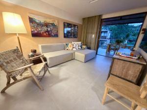 a living room with a couch and a chair at Diamantino Residence - Barro in Mucugê