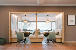 a dining room with a table and chairs at Hotel Promenade in Bad Füssing