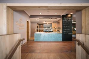 a restaurant with a chalkboard on the wall at Hotel Promenade in Bad Füssing +32 photos