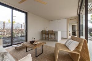 a living room with a couch and a table at Gara Suite Boutique Design Villa Private Pool in Lajares