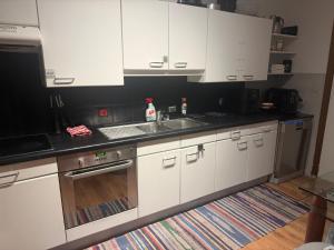 a kitchen with white cabinets and a sink at Perk25A in Steenokkerzeel +103 photos