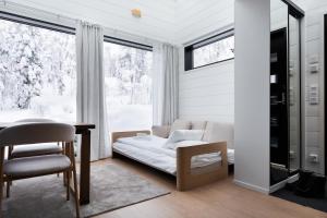 a bedroom with a bed and a desk and a window at Levin Primus - Your Glass-Roof Gateway to Laplands Magic in Levi