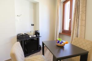 a small living room with a table and a chair at Affittacamere Ca Stella Antares a La Morra centro in La Morra