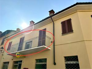 a large white building with a balcony on it at Affittacamere Ca Stella Antares a La Morra centro in La Morra