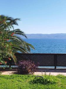 a bench with a view of the ocean at Villa Cortesia Maritima - seaside & private in Amarynthos