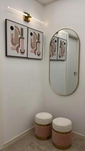 a mirror and two stools in a room at Odivelas Place 1 in Odivelas