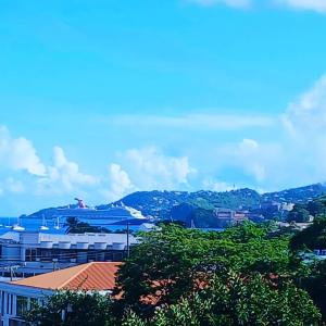 a view of a city with mountains in the background at Atrium Apartments - Frangipani Suite in Grand Anse