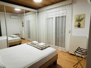 a bedroom with a bed and a mirror at Elaia Horizon Makri in Alexandroupoli