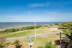 a golf course with the ocean in the background at Doggone Perfect - Village at Nags Head, Soundfront, Golf Course View, Pool, Hot Tub, Pets OK, Flex Stays in Nags Head