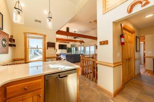 a kitchen with wooden cabinets and a counter top at Doggone Perfect - Village at Nags Head, Soundfront, Golf Course View, Pool, Hot Tub, Pets OK, Flex Stays in Nags Head +54 photos