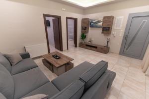 a living room with a couch and a table at Efraim Oasis in Kos