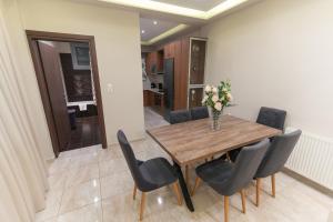 a dining room with a wooden table and chairs at Efraim Oasis in Kos