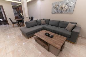 a living room with a couch and a coffee table at Efraim Oasis in Kos