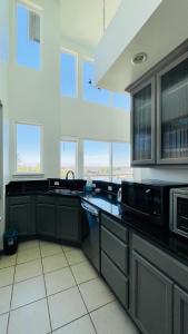 a kitchen with a sink and a microwave at 2B2B apartment with stunning window -7min to Dome in Tacoma
