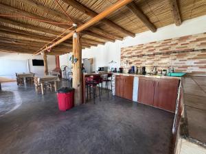 a large kitchen with a bar and a dining area at Posada Solar de las Piedras in Fiambalá