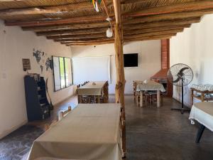 a room with tables and chairs and a fan at Posada Solar de las Piedras in Fiambalá +2 photos