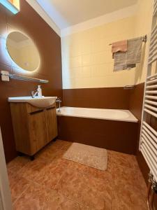 a bathroom with a tub and a sink at Aldrovské Trio in Vítkovice +14 photos