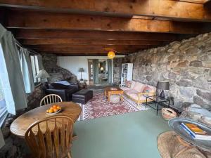a living room with a stone wall at Tucson Mountain Guest Ranch in Tucson