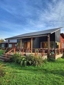 a large house with a fence in front of it at Vuelta al Sur in Puelo