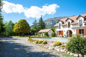 a house with a swimming pool in front of a yard at L'auberge de Charance in Gap