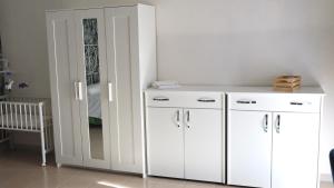 a white cabinet and a mirror in a room at ENGI CASA VACANZE in Naples