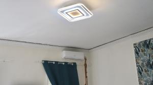 a ceiling light in a room with a blue curtain at ENGI CASA VACANZE in Naples