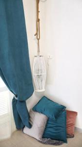 a corner of a room with a curtain and pillows at ENGI CASA VACANZE in Naples