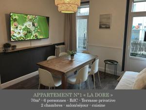 a living room with a wooden table and chairs at La Maison des Familles 10 appartements in Le Mont-Dore +61 photos