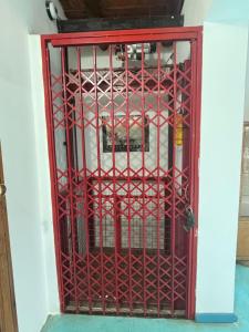 an open red gate in a room at Villa Pellegrini in Trapiche