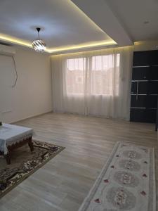 an empty living room with a couch and a large window at Appartement indépendant de villa in Tipaza +5 photos